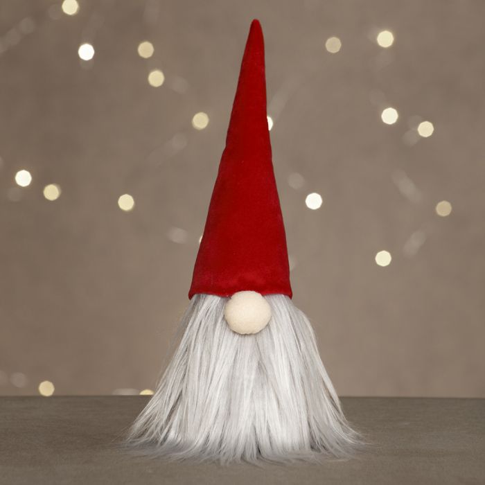 Un duende con una barba larga y un sombrero de duende de terciopelo