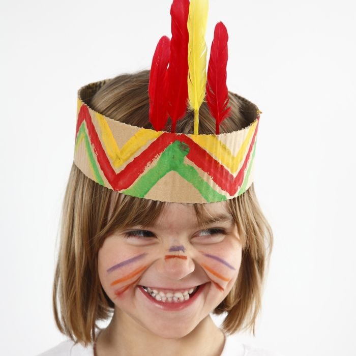 A Head Dress from painted corrugated Board with Feathers