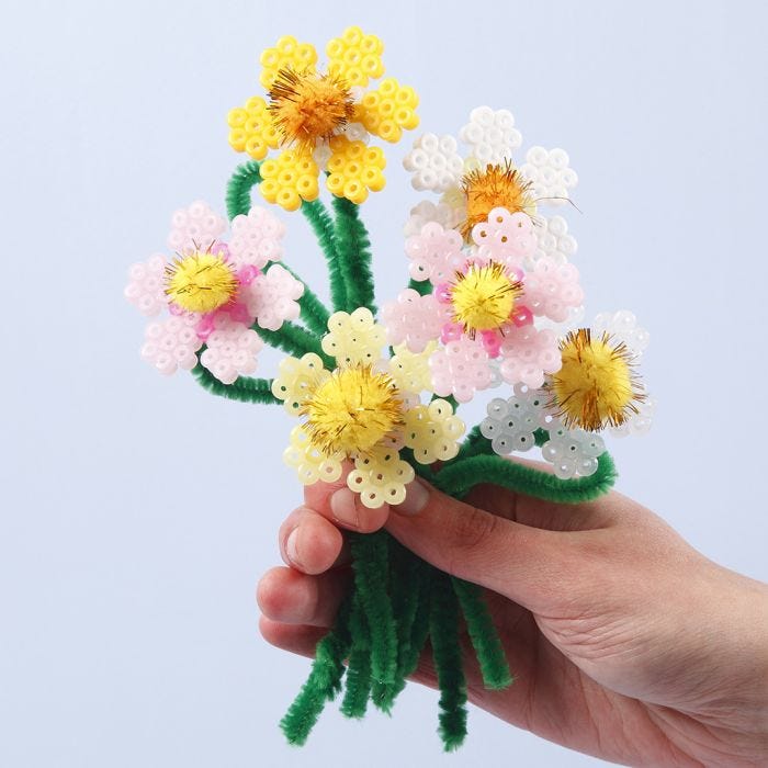 Flores hechas a partir de cuentas de fusible Nabbi y limpiapipas con pompones.