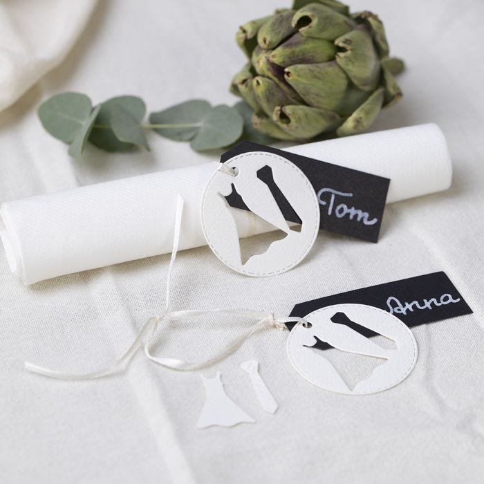 A wedding place card with a dress and a tie