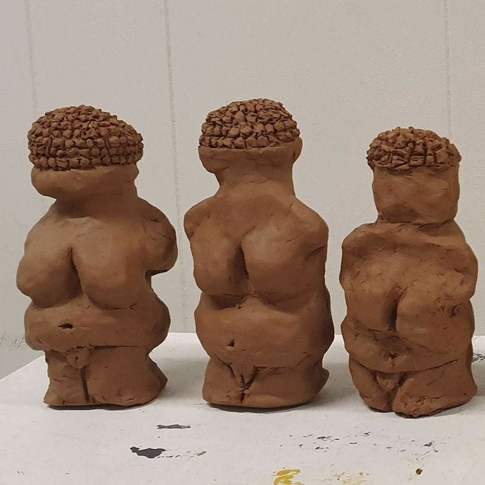 Female sculptures from red earth clay