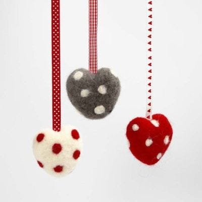 A Needle Felted Heart with Dots and a Decorative Ribbon
