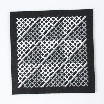 A Cushion with a graphic Cross-Stitch Pattern