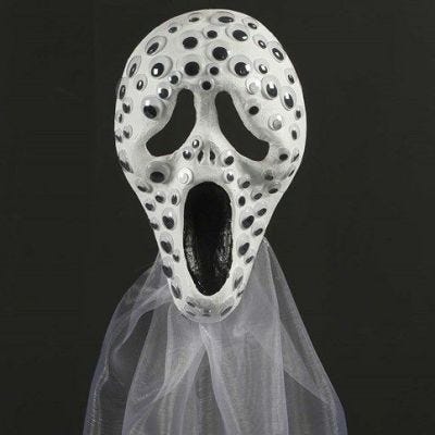 A Scream mask decorated with wiggle Eyes and Organza