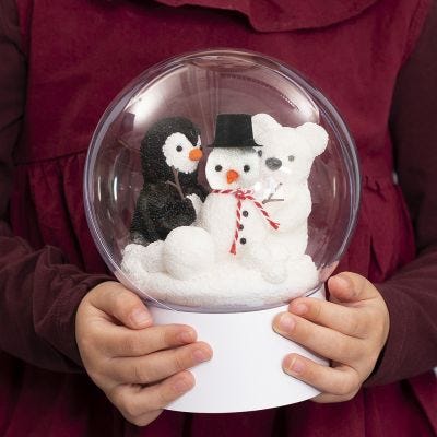 Un adorno transparente con soporte y un muñeco de nieve