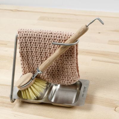 Un paño de cocina tejido a ganchillo con un patrón de estilo de puntada de concha