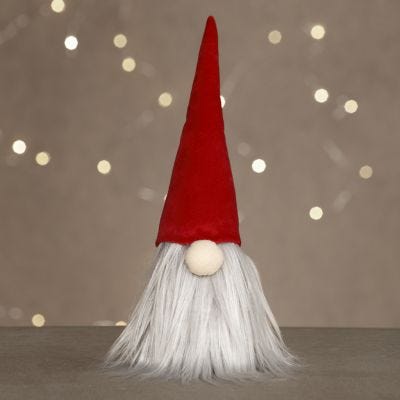 Un duende con una barba larga y un sombrero de duende de terciopelo