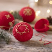 A Christmas bauble crocheted from cotton yarn