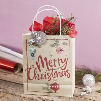 Una bolsa de regalo con un diseño navideño con una estrella, espumillón y papel china