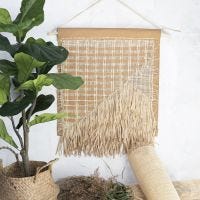 A wall hanging decoration from faux leather paper, rattan and raffia paper yarn