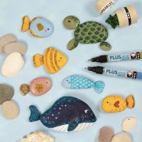 Sea creatures painted on stones with markers and decorated with bio glitter